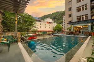 a swimming pool in the middle of a building at The Oversleep Catba Hostel in Cat Ba