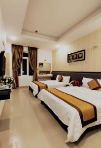 Giường trong phòng chung tại Hương Trà Hotel apartment