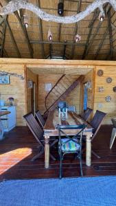 comedor con mesa y sillas en una cabaña en Hippo Lagoon Cabin, en Ntabis