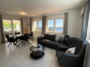 a living room with a couch and a table at Villa Milina Korcula in Vela Luka