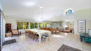 a dining room and living room with a table and chairs at Your Beach House in Pearl Beach