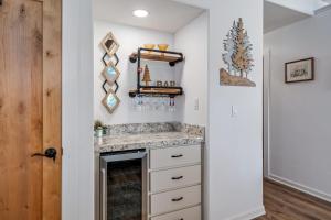 a kitchen with a counter and a fireplace at Up On V1 - Golf Course Home with Views home in Groveland