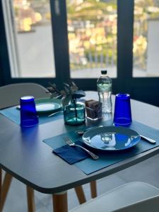 a table with a blue plate on a table at TaliaKà B & B in Lipari