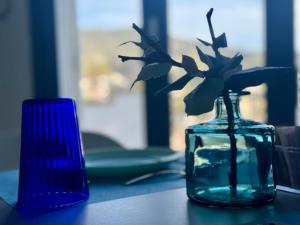 a glass vase with a flower in it on a table at TaliaKà B & B in Lipari