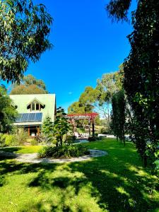 a green yard with a building in the background at The Muddy in Alexandra