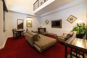 a living room with a couch and a table at Hotel Puri Melaka in Malacca