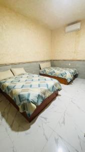 Een bed of bedden in een kamer bij Puerto Xperiencias rooms