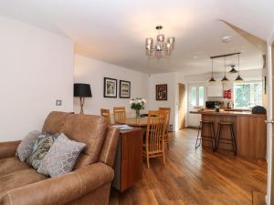 a living room and kitchen with a couch and a table at The Sanctuary in Windermere