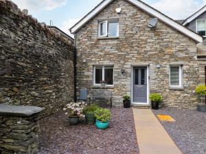 a stone house with a stone wall at The Sanctuary in Windermere
