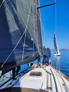 two men on a sail boat in the water at Torre Subrosa, vasca in camera cromoterapia in Viterbo