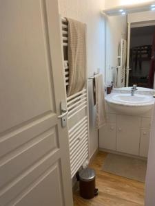 a bathroom with a sink and a mirror and a door at Orcières Merlette - Haut Champsaur, classé 3* in Orcières