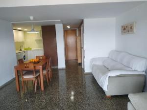 a living room with a couch and a table at Desconexión y Relax in Mareny Blau