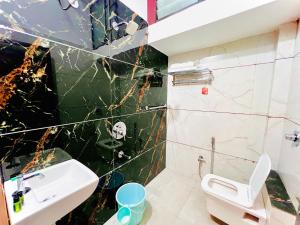 a bathroom with a sink and a toilet at Kailashbhavan Oasis - Full Villa By AP Villas in Ujjain