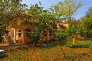 a house with a garden in front of it at Auro Wellness Castle in Puducherry