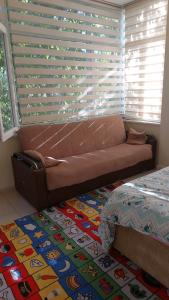 a couch in a living room with a window at Tatvan Kamp Alanı in Tatvan