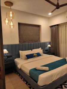 a bedroom with a large bed with two towels on it at Kudrat Paradise - Full Villa By AP Villas in Indore