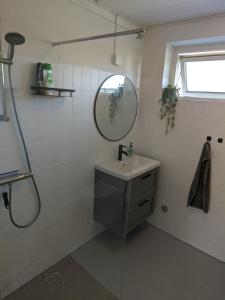 a bathroom with a sink and a mirror at Sommerhus ved strand og lystbådhavn Søby - Ærø in Søby