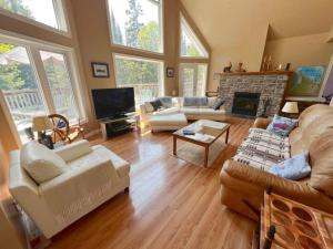 a large living room with couches and a fireplace at Tip-of-Peninsula Lookout Cottage in Tobermory