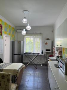 a kitchen with a refrigerator and a table in it at Korkem in Shymkent