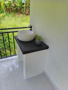 a bathroom with a sink on a counter with a balcony at Evi's Place in Galle