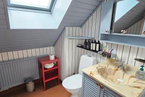a bathroom with a sink and a toilet and a window at Fiskarvillan in Simrishamn