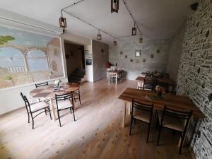 a room with tables and chairs and a brick wall at Anna Home B&B in Areni