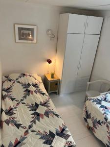 a bedroom with a bed and a cabinet and a table at 120 m fra stranden med ro og hygge in Kalundborg