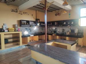 a kitchen with a counter top in a room at Kuteeram1 in Kumbakonam