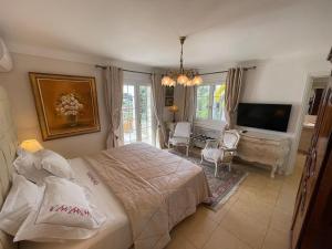 a bedroom with a bed and a flat screen tv at La Bergerie B&B in Vence