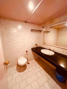 uma casa de banho com um lavatório e um WC em Ramayan Resort, in City Centre Manali By Ramanand Sagar em Manali