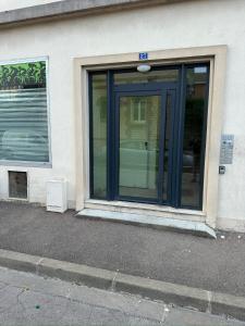 uma porta de vidro de um edifício numa rua em Appart- hotel Love Room YSCHOOL em Troyes