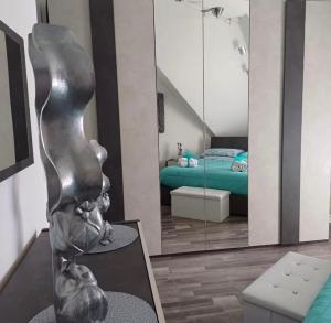 a rendering of a bedroom with a statue in front of a mirror at Casa Harmony in Leonforte