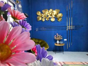 a blue room with flowers and gold chandeliers at alley homestay in Hanoi