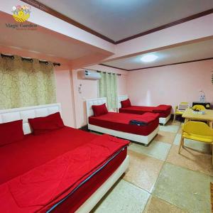 1 dormitorio con 2 camas, mesa y sillas en Magic Garden Residence Bangkok, en Bangkok