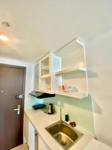 a kitchen with a sink and white cabinets at GreenLine Service Aparts - Luxious, Heart of city in Ho Chi Minh City +180 photos