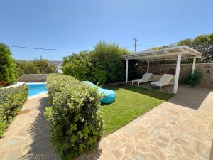 a backyard with a pool and a gazebo at Grace Villa Mykonos in Mikonos