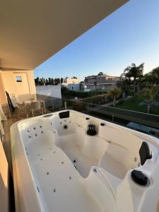 a large white bath tub sitting on top of a balcony at Le Murge Del Salento Hotel b&b Depandance in Uggiano la Chiesa