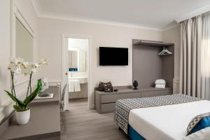 een hotelkamer met een bed en een badkamer bij Hotel Michelangelo in Sorrento