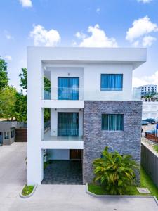 a modern house with a white facade at Stay Play Away Residences - Luxury 5 bed, Airport Residential in Accra