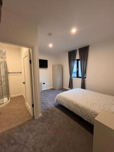 a hotel room with a bed and a television at Deerpark luxury 3 bed retreat in Cashel