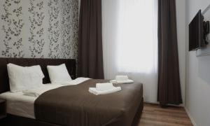 Katil atau katil-katil dalam bilik di Viva La Vienna Apartments