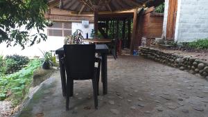 una mesa negra y una silla en un patio en Sierra Tayrona hostel, en El Zaino