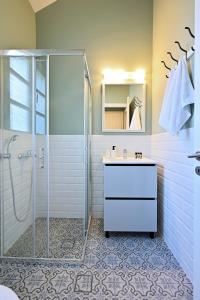 baño blanco con ducha y lavamanos en Villa Pelagos, en Asos