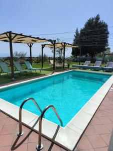 una piscina en un complejo con sillas en Villa Egle Belpasso, villa vacanza con piscina, en Belpasso