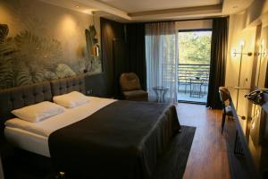 a hotel room with a bed and a balcony at Amorium Hotel in Kastamonu