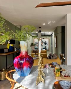 a red and blue vase sitting on top of a table at Villa Augustine in Tangier