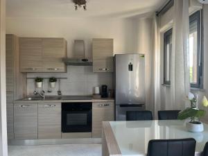 a kitchen with a refrigerator and a table with chairs at Lovely Apartment in Parma +19 photos