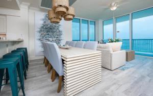 a kitchen and dining room with a table and chairs at Perdido Dunes Tower 9E condo in Orange Beach