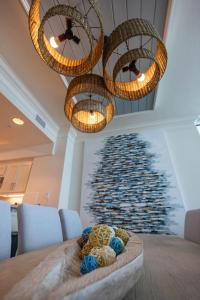 a dining room with two chandeliers and a wall of water at Perdido Dunes Tower 9E condo in Orange Beach