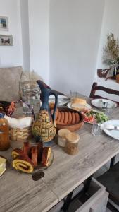 a table with food and a vase on top of it at Latvji in Kutaisi